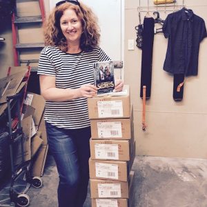 A.L. Tait with boxes of The Book Of Secrets (Ateban Cipher #1) at her local bookshop